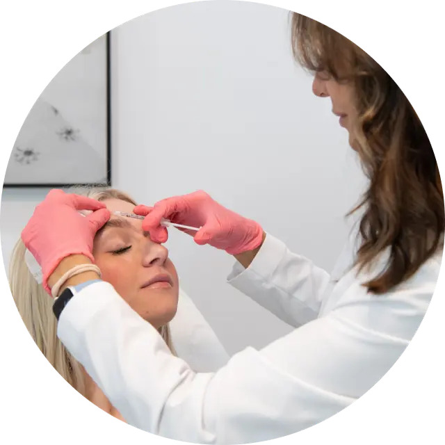 Dr. Ellie injecting Botox to a patient on the forehead